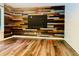 Bright living room with hardwood floors and a wood-paneled accent wall with a modern design at 3748 Woodrose Ct, Snellville, GA 30039