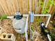 Close up of a pool filter and pump with electrical box against a wooden fence and lush foliage at 3748 Woodrose Ct, Snellville, GA 30039