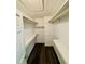 Walk-in closet with wood floors and many built-in shelves at 3748 Woodrose Ct, Snellville, GA 30039