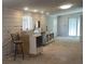 Unfinished kitchen featuring white plank walls, stainless steel appliances and sink, and a black metal bar stool at 7301 Staton Pl, Acworth, GA 30102