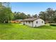 Large backyard view of the white brick home with a well-maintained lawn at 2744 Preston Dr, Decatur, GA 30034
