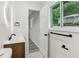 Stylish bathroom featuring a modern vanity, an illuminated mirror, and black fixtures at 2744 Preston Dr, Decatur, GA 30034