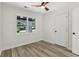 Bright bedroom featuring wood-look flooring, a ceiling fan, and natural light from the window at 2744 Preston Dr, Decatur, GA 30034