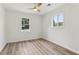 Bright bedroom with wood-look flooring, white walls, and natural light from windows at 2744 Preston Dr, Decatur, GA 30034