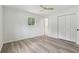 Bedroom features a double closet, wood-look floors, white walls, and a window at 2744 Preston Dr, Decatur, GA 30034