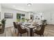 Dining room with seating for eight, modern decor, and bright view into the kitchen at 2744 Preston Dr, Decatur, GA 30034