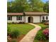 Charming single-story home featuring a well-manicured lawn, brick walkway, and beautiful landscaping at 2744 Preston Dr, Decatur, GA 30034