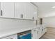 Modern kitchen featuring stainless steel appliances, white cabinets, stone countertops, and tile backsplash at 2744 Preston Dr, Decatur, GA 30034