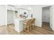 Bright kitchen features white cabinets, stainless appliances, breakfast bar with seating, and hardwood flooring at 2744 Preston Dr, Decatur, GA 30034