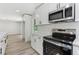 Bright kitchen featuring stainless steel appliances, white cabinets, white countertops, and hardwood flooring at 2744 Preston Dr, Decatur, GA 30034