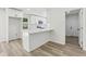 Bright kitchen features white cabinets, stainless appliances, breakfast bar with seating, and hardwood flooring at 2744 Preston Dr, Decatur, GA 30034