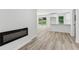 Open-concept living space featuring an electric fireplace and new hardwood floors at 2744 Preston Dr, Decatur, GA 30034