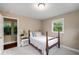 Inviting bedroom with a white bed, hardwood floors, and a bright window at 299 Stockwood Dr, Woodstock, GA 30188