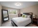 Comfortable bedroom features a full bed, a window, and neutral walls at 299 Stockwood Dr, Woodstock, GA 30188