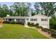 Ranch-style house with charming curb appeal, mature trees, and a well-maintained lawn at 299 Stockwood Dr, Woodstock, GA 30188