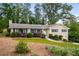 Charming home with well-manicured lawn, mature bushes, and inviting curb appeal in a peaceful setting at 299 Stockwood Dr, Woodstock, GA 30188