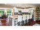 Bright kitchen boasts granite counters, stainless appliances, and breakfast bar seating four at 299 Stockwood Dr, Woodstock, GA 30188