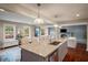 Open kitchen with large island and granite counters, overlooks the spacious living room at 299 Stockwood Dr, Woodstock, GA 30188