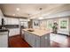 Modern kitchen features stainless steel appliances, granite counters, and an island with seating at 299 Stockwood Dr, Woodstock, GA 30188