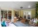 Inviting covered patio with comfortable seating, neutral brick, and view into dining room with lots of natural light at 299 Stockwood Dr, Woodstock, GA 30188