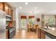 Modern kitchen with stainless steel appliances, granite countertops, and an adjacent dining area with ample natural light at 3567 Sycamore Bnd, Decatur, GA 30034
