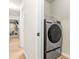 Modern laundry room with a front-load washer and dryer and hallway access at 3567 Sycamore Bnd, Decatur, GA 30034