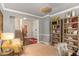 Comfortable living room area with neutral tones, bookshelves, and view of the staircase and dining area at 3567 Sycamore Bnd, Decatur, GA 30034