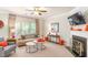 Cozy living room with a fireplace, neutral colors, and large windows providing natural light at 3567 Sycamore Bnd, Decatur, GA 30034