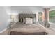 Elegant main bedroom showcasing a tufted headboard, mirrored nightstands, and neutral tones at 3567 Sycamore Bnd, Decatur, GA 30034