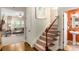 Carpeted staircase leads to the upper level, with a glimpse into the living room and an adjacent half bathroom at 3567 Sycamore Bnd, Decatur, GA 30034