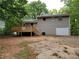 View of the home's backyard, featuring a deck and a garage at 4063 Feather Dr, Douglasville, GA 30135
