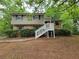 Split level home has a brick and siding facade and a elevated porch and stairs at 4063 Feather Dr, Douglasville, GA 30135