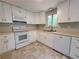 The kitchen features white cabinets, tile floors, and a functional layout for cooking at 4063 Feather Dr, Douglasville, GA 30135