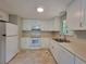 Well-lit kitchen boasts white cabinets, modern appliances, and a functional layout at 4063 Feather Dr, Douglasville, GA 30135