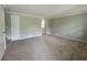 Bright living room with neutral carpet and paint, ready for your personal touches at 4063 Feather Dr, Douglasville, GA 30135