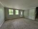Large carpeted living room, neutral paint, front door and a stairway to the second level at 4063 Feather Dr, Douglasville, GA 30135