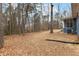 Large backyard with mature trees provides privacy and space for outdoor activities and entertaining at 4145 White Oak Dr, Winston, GA 30187