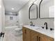 Bathroom featuring a double sink vanity with marble countertop and tiled shower and floors at 4145 White Oak Dr, Winston, GA 30187