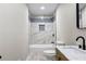 Modern bathroom featuring tile surround tub and shower with a stylish sink and vanity at 4145 White Oak Dr, Winston, GA 30187
