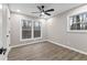 Bright bedroom with two windows, modern ceiling fan, and wood flooring at 4145 White Oak Dr, Winston, GA 30187
