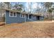 Landscaped front yard of a single-story home with a blue brick exterior and welcoming entryway at 4145 White Oak Dr, Winston, GA 30187