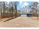 View of the two-car garage. Long driveway leads to this charming home. Bordered by trees providing privacy at 4145 White Oak Dr, Winston, GA 30187