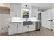 Updated kitchen showcasing a stainless steel dishwasher, island sink, and light cabinets at 4145 White Oak Dr, Winston, GA 30187