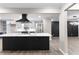 Modern kitchen featuring island with cooktop and black vent hood at 4145 White Oak Dr, Winston, GA 30187