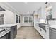 Open kitchen with stainless steel appliances, white cabinets, a range hood, and hardwood floors at 4145 White Oak Dr, Winston, GA 30187
