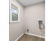 Laundry room with wood-look flooring and utility connections at 4145 White Oak Dr, Winston, GA 30187