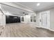 Spacious, open-concept living area has stylish black accent wall and contemporary lighting at 4145 White Oak Dr, Winston, GA 30187