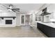 Living room featuring a painted fireplace, ceiling fan, and access to a screened porch via french doors at 4145 White Oak Dr, Winston, GA 30187