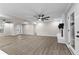 Living room with hardwood floors, ceiling fan, and easy access to a fireplace and the backyard through the French doors at 4145 White Oak Dr, Winston, GA 30187