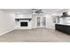 Open layout with painted fireplace, French doors, and view into the kitchen with black and white countertops at 4145 White Oak Dr, Winston, GA 30187